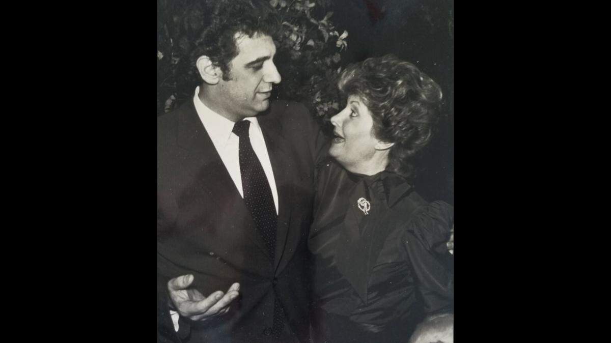A photo of a framed picture hanging in the home of Penelope Angleton Behrend features the opera supporter (right) with opera star Placido Domingo at her home at a cast party.