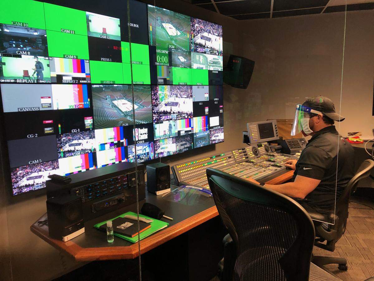 A member of the Miami Heat’s broadcast team working at AmericanAirlines Arena, as it prepares to air games amid the COVID-19 pandemic.