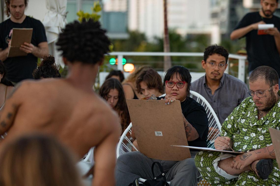 People make figure drawings of artist Mychal Clayton at Hotel Greystone during the Raw Figs Pop Up in Miami Beach, Florida on Wednesday, August 25, 2022.