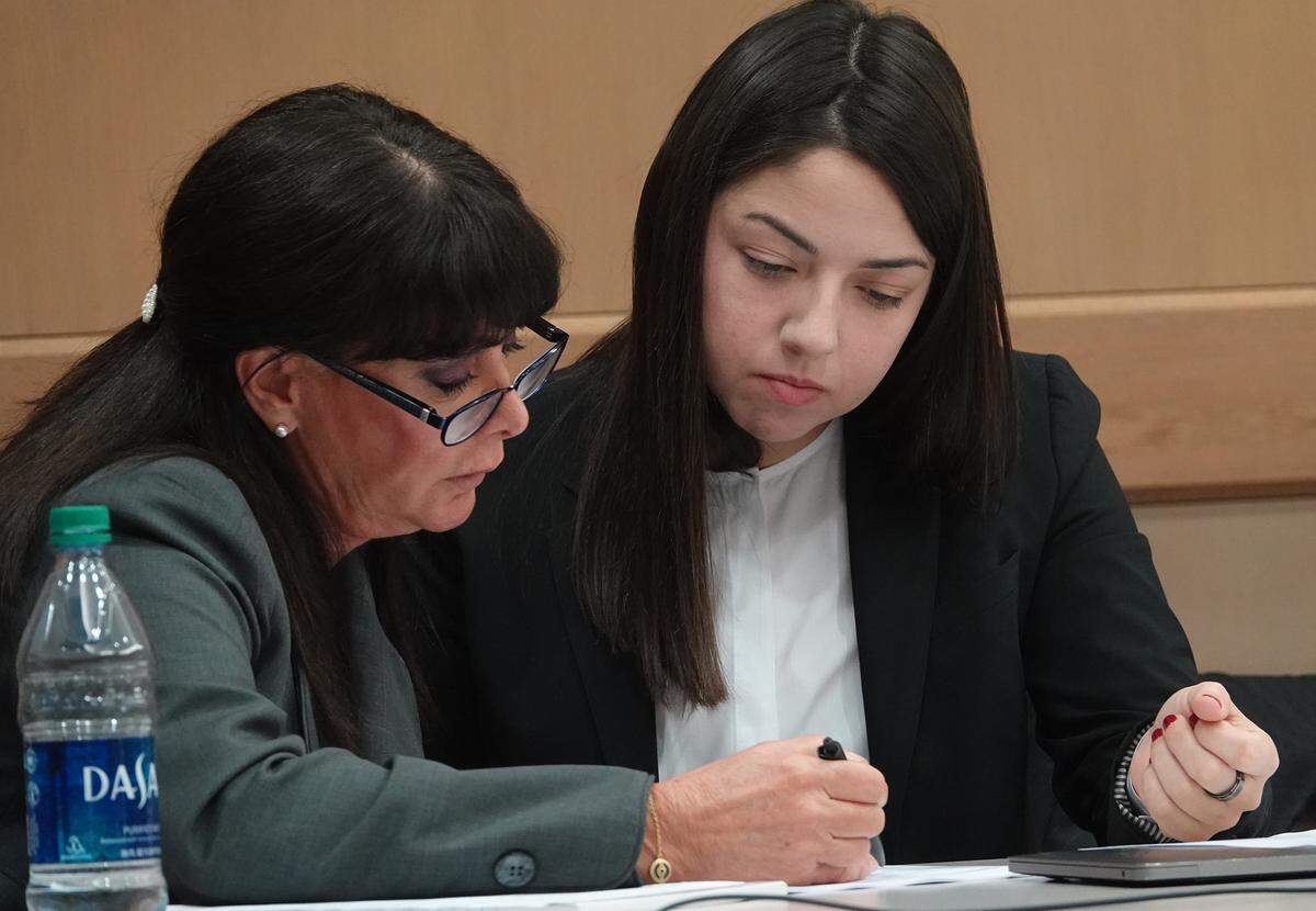 Former Hallandale Beach Mayor Joy Cooper confers with one of her attorneys, Shana Korda, at the Broward County Courthouse before the case went to the jury on Tuesday.
