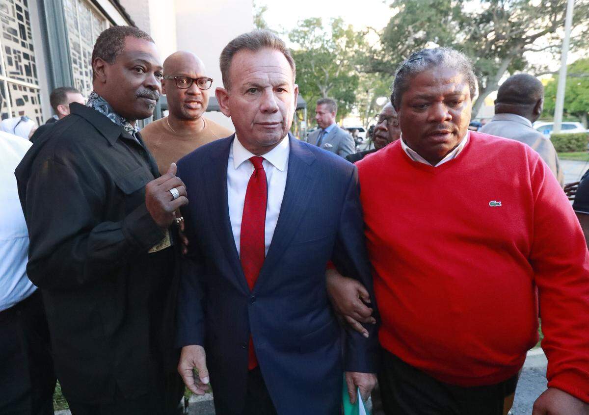 Suspended Broward County Sheriff Scott Israel, center, leaves a news conference surrounded by supporters Friday, Jan. 11, 2019, in Fort Lauderdale, Fla., after new Florida Gov. Ron DeSantis suspended him, over his handling of last February’s massacre at Marjory Stoneman Douglas High School. (AP Photo/Wilfredo Lee)