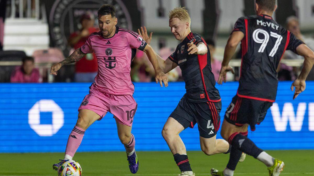 Inter Miami forward Lionel Messi (10) runs with the ball as D.C. United midfielder Matti Peltola (4) defends in second half of their MLS match at Chase Stadium on Saturday, May 18, 2024, in Fort Lauderdale, Fla.