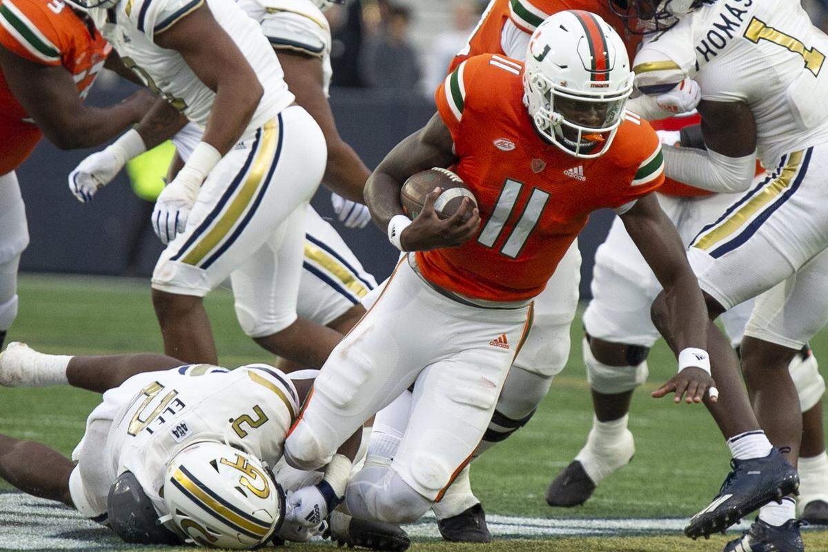 Miami quarterback Jacurri Brown (11) is tackled by Georgia Tech’s linebacker Ayinde Eley (2) in the first half of an NCAA college football game Saturday, Nov. 12, 2022, in Atlanta. (AP Photo/Hakim Wright Sr.)