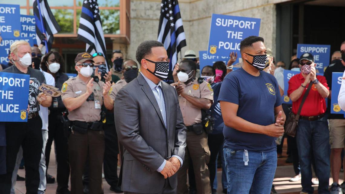 Miami-Dade Police lieutenant and union vice president John Jenkins, seen here [right] supporting a suspended officer last year outside police headquarters, has been relieved of duty pending the outcome of an investigation by Palm Beach County Sheriff’s Office deputies into an incident April 24.