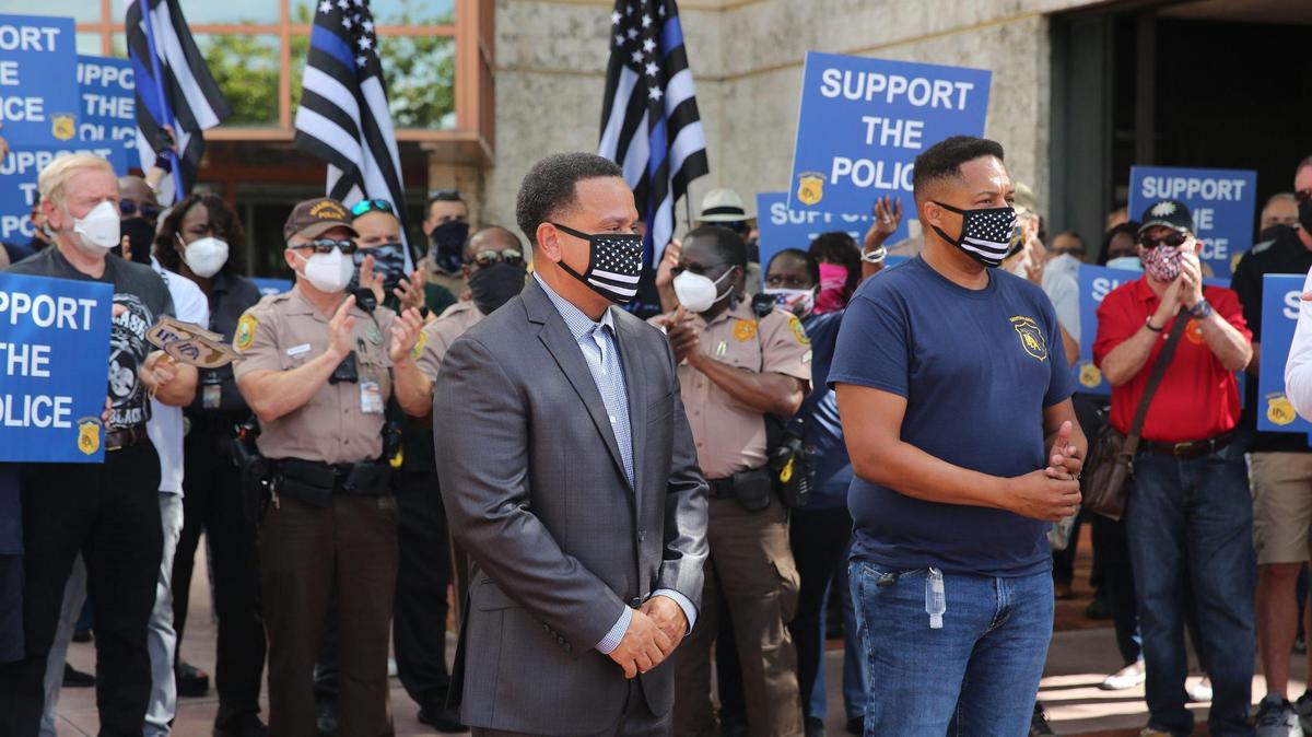 Miami-Dade Police lieutenant and union vice president John Jenkins, seen here [right] supporting a suspended officer last year outside police headquarters, has been relieved of duty pending the outcome of an investigation by Palm Beach County Sheriff’s Office deputies into an incident April 24.