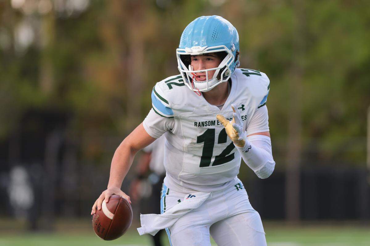 Ransom Everglades quarterback Matthew Guevara (12) runs with the football against Gulliver Prep during the third quarter of a Region 4-2A quarterfinal football playoff game at Gulliver Prep in Pinecrest, Florida, Friday, Nov. 14, 2025.
