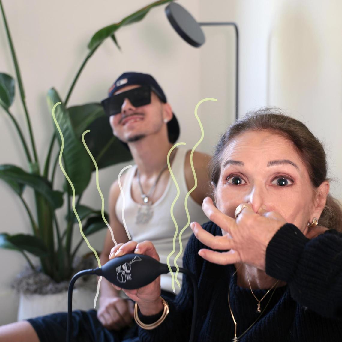 Sebastian Romney, left, enjoys the act of flatulence while his grandmother, Jenny Romney, uses the Fart Vac.