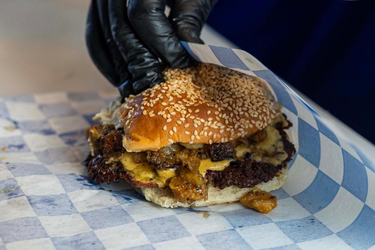 The Lala Smash burger, with American cheese, grilled onions, Lala sauce and pickles at Lala’s Burgers at Lincoln’s Beard Brewing Co. in Miami.