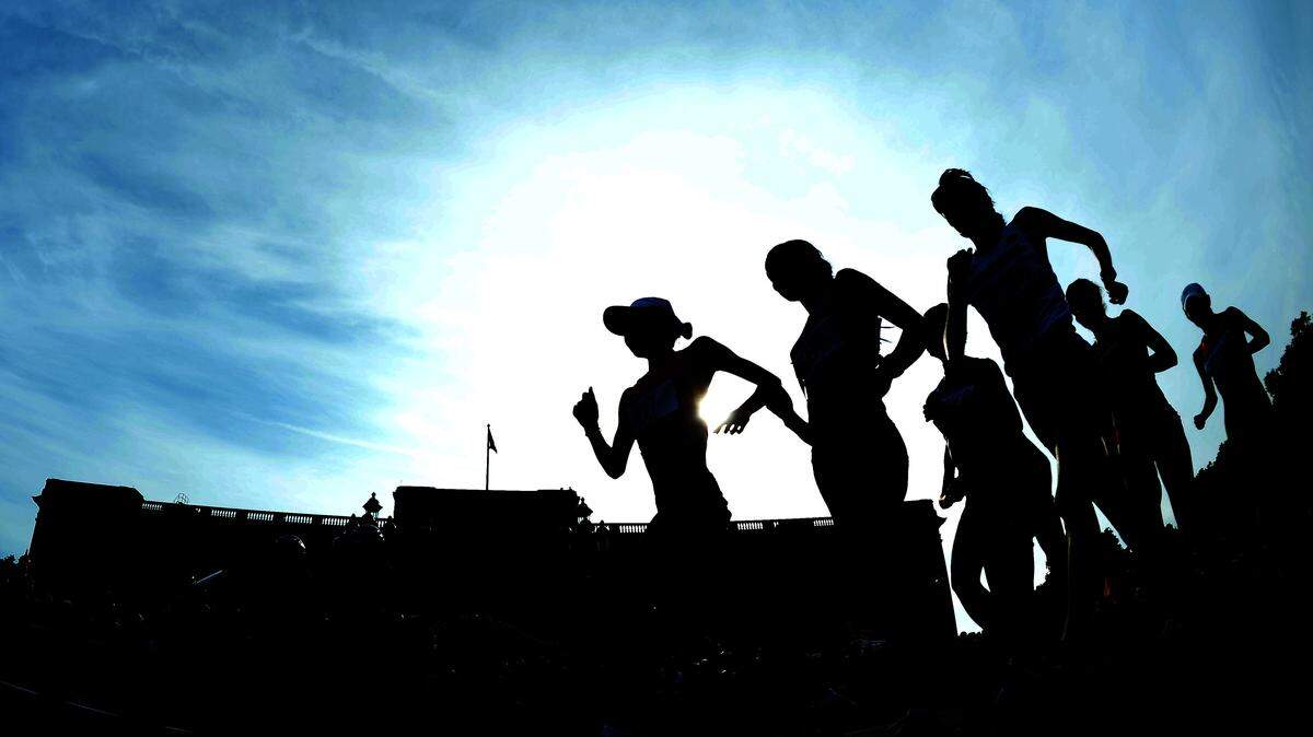 Silhouette of race walkers competing in front of Buckingham Palace during the Women’s 20km Walk final on Day 15 of the London 2012 Olympic Games on the streets of London on August 11, 2012 in London, England.
