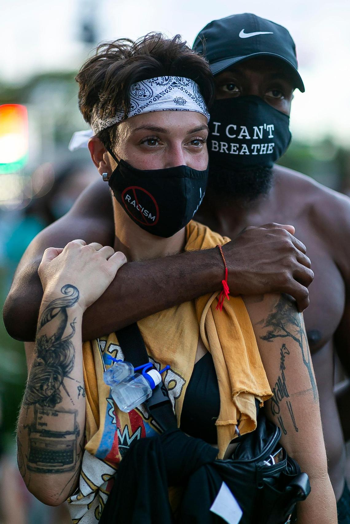 Ashly Alvarez, 32, and Emeril McCutcheon, 32, embrace as they listen to a group of speakers during an anti-racism protest in MiamiÕs Little Haiti neighborhood on Saturday, June 13, 2020.