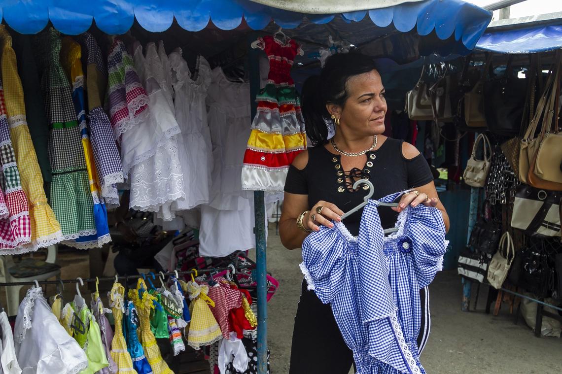 Marilin Garcia Franco sells dresses for Santeria statues and religious festivals at the Virgen del Camino market on the outskirts of Havana, Cuba.