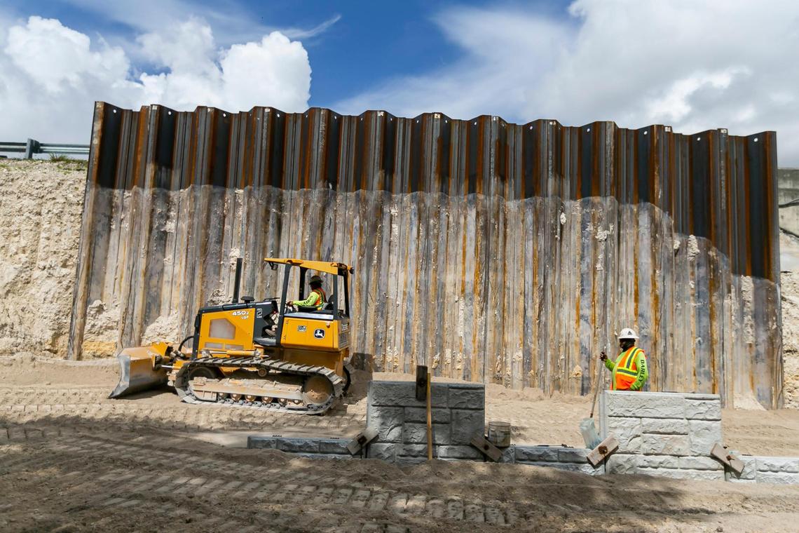 Employees work on widening a section of the highway as part of the construction project happening on the I-395, SR-836 and I-95 near downtown Miami and Overtown on Tuesday, June 8, 2021.