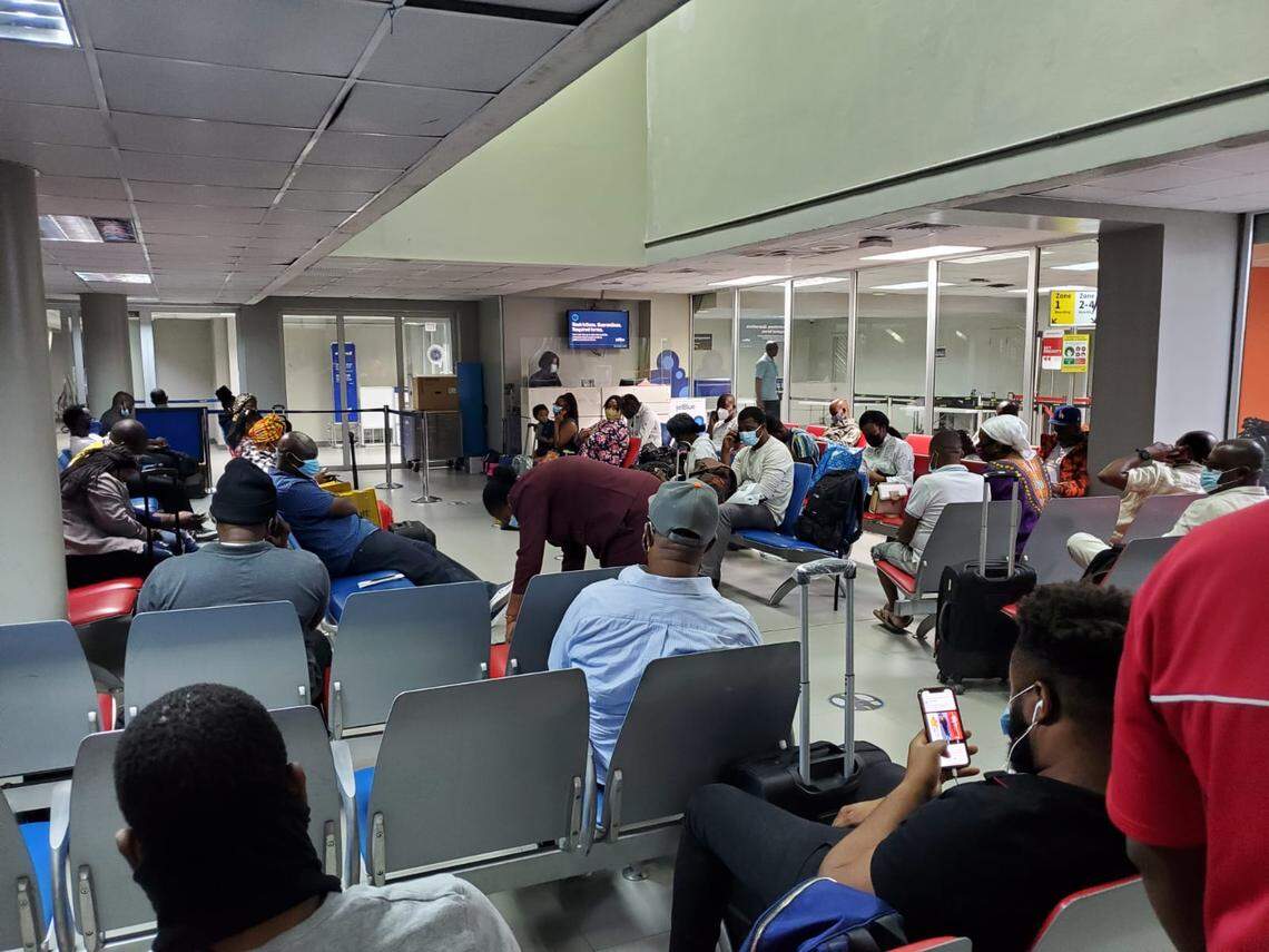 U.S.-bound travelers waiting inside a departure lounge at the Toussaint Louverture International Airport in Port-au-Prince Haiti, Tuesday, Jan. 26, 2021. The lounge is usually packed with travelers, but many were denied boarding because of new U.S. rules requiring a negative COVID-19 test to board.