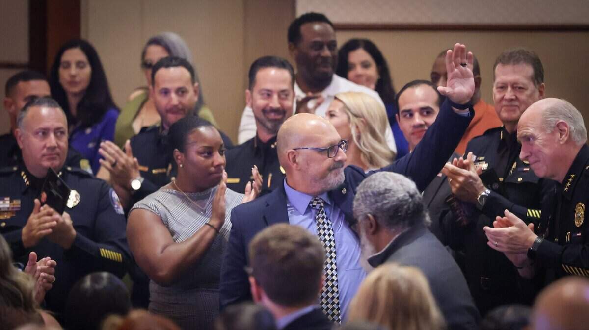 Outgoing Police Chief Manuel Morales waves to supporters after Miami Police Chief Edwin Lopez acknowledges his contribution and guidance while giving his remarks after taking the oath of office during his swearing-in ceremony at the Ziff Ballet Opera House on Tuesday, June 16, 2026, in Miami.Lopez, who previously served as deputy chief, was joined by city officials, family members and community leaders as he formally assumed leadership of the department. The ceremony marked a new chapter for the city's police force.