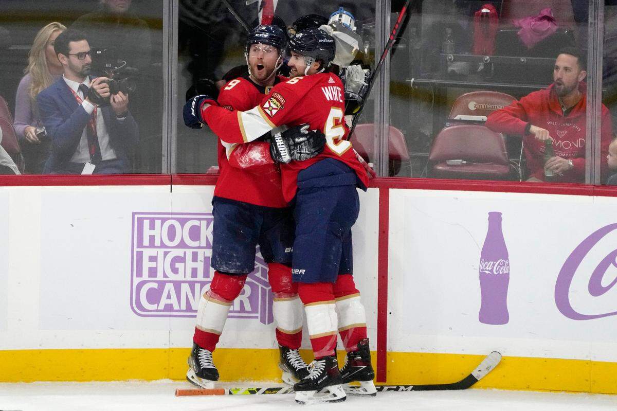 Florida Panthers center Sam Bennett (9) celebrates with center Colin White (6) after scoring a goal during the third period of an NHL hockey game against the Edmonton Oilers, Saturday, Nov. 12, 2022, in Sunrise, Fla. (AP Photo/Lynne Sladky)