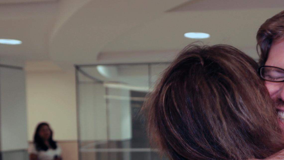 Colleague Luisa Yanez, left, gives Jim Wyss, a welcome hug upon his arrival.  Miami Herald reporter Jim Wyss arrived at Miami International Airport after being detained by Venezuela for three days on Sunday, November 10, 2013.