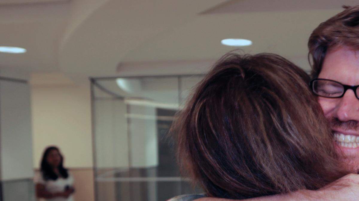 Colleague Luisa Yanez, left, gives Jim Wyss, a welcome hug upon his arrival.  Miami Herald reporter Jim Wyss arrived at Miami International Airport after being detained by Venezuela for three days on Sunday, November 10, 2013.