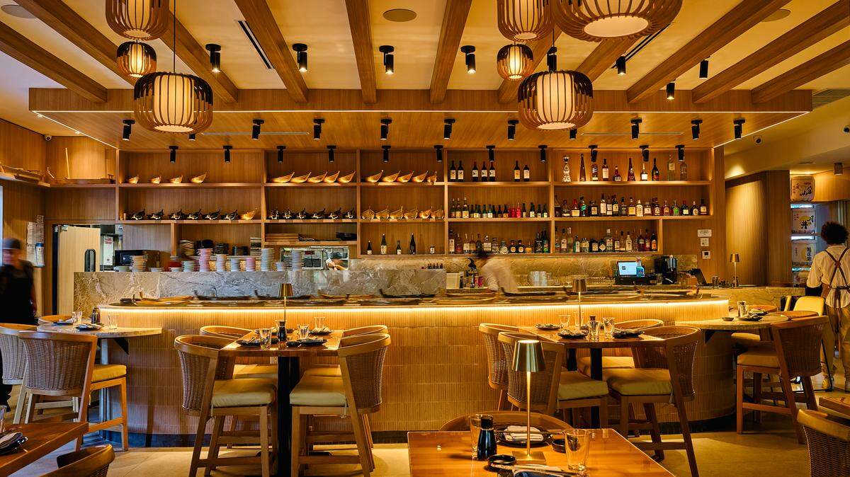 The counter at the new Tokyo Tuna in South Miami, which features a sushi river that delivers your dinner via little boats.
