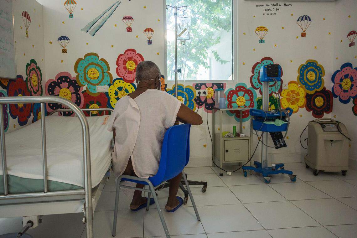 A COVID-19 patient sits in a room at the Doctors Without Borders Drouillard Hospital in Cite Soleil, Haiti, on June 3, 2020.