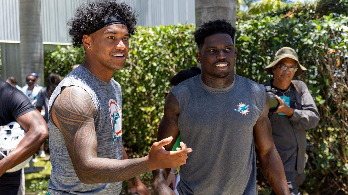 Miami Dolphins quarterback Tua Tagovailoa (1) interacts with teammate and Tyreek Hill (10) during NFL mandatory minicamp at Baptist Health Training Complex in Hard Rock Stadium on Tuesday, June 4, 2024, in Miami Gardens, Fla.