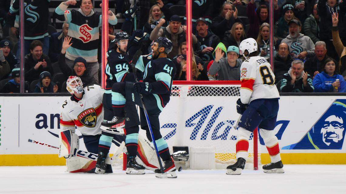 Dec 12, 2023; Seattle, Washington, USA; Seattle Kraken center Devin Shore (94) and left wing Pierre-Edouard Bellemare (41) celebrate after Bellemare scored a goal against the Florida Panthers during the third period at Climate Pledge Arena.