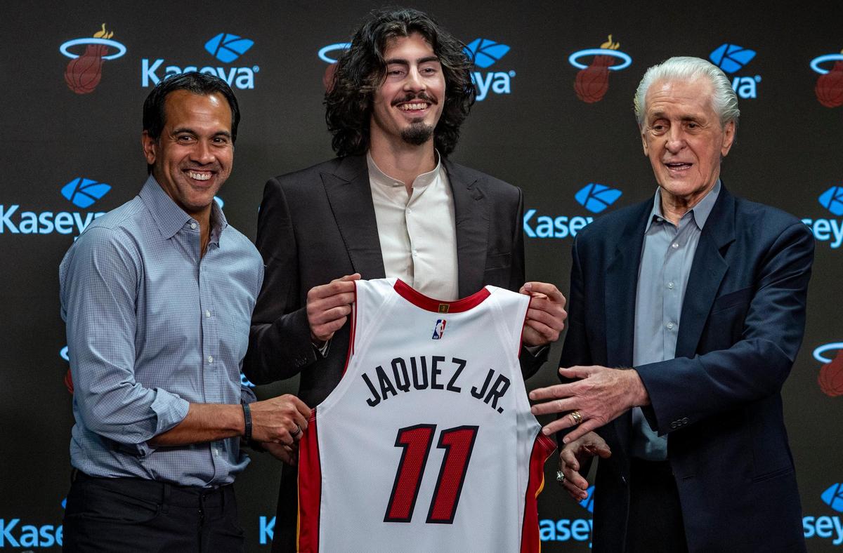 The Miami Heat’s first-round draft pick Jaime Jaquez, Jr., center flanked by Miami Heat Head Coach Erik Spoelstra, left, and Miami Heat President Pat Riley pose for photos during a press conference at Kaseya Center.