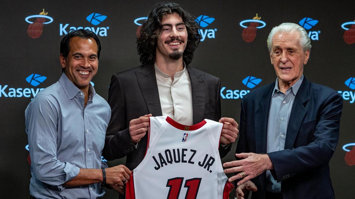 The Miami Heat’s first-round draft pick Jaime Jaquez, Jr., center flanked by Miami Heat Head Coach Erik Spoelstra, left, and Miami Heat President Pat Riley pose for photos during a press conference at Kaseya Center.