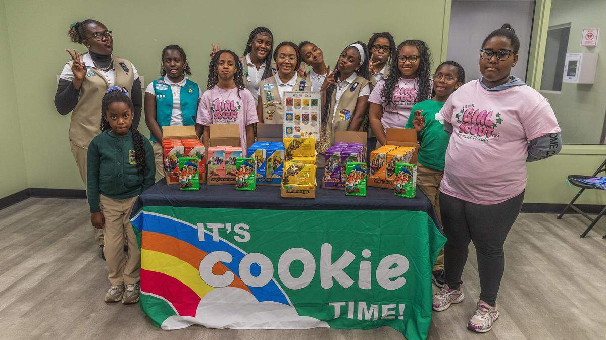A group of Girl Scouts members posed by a display of cookies boxes during a meeting at the Betty T. Ferguson Recreational Complex, in Miami Gardens on Tuesday, January 28, 2026.