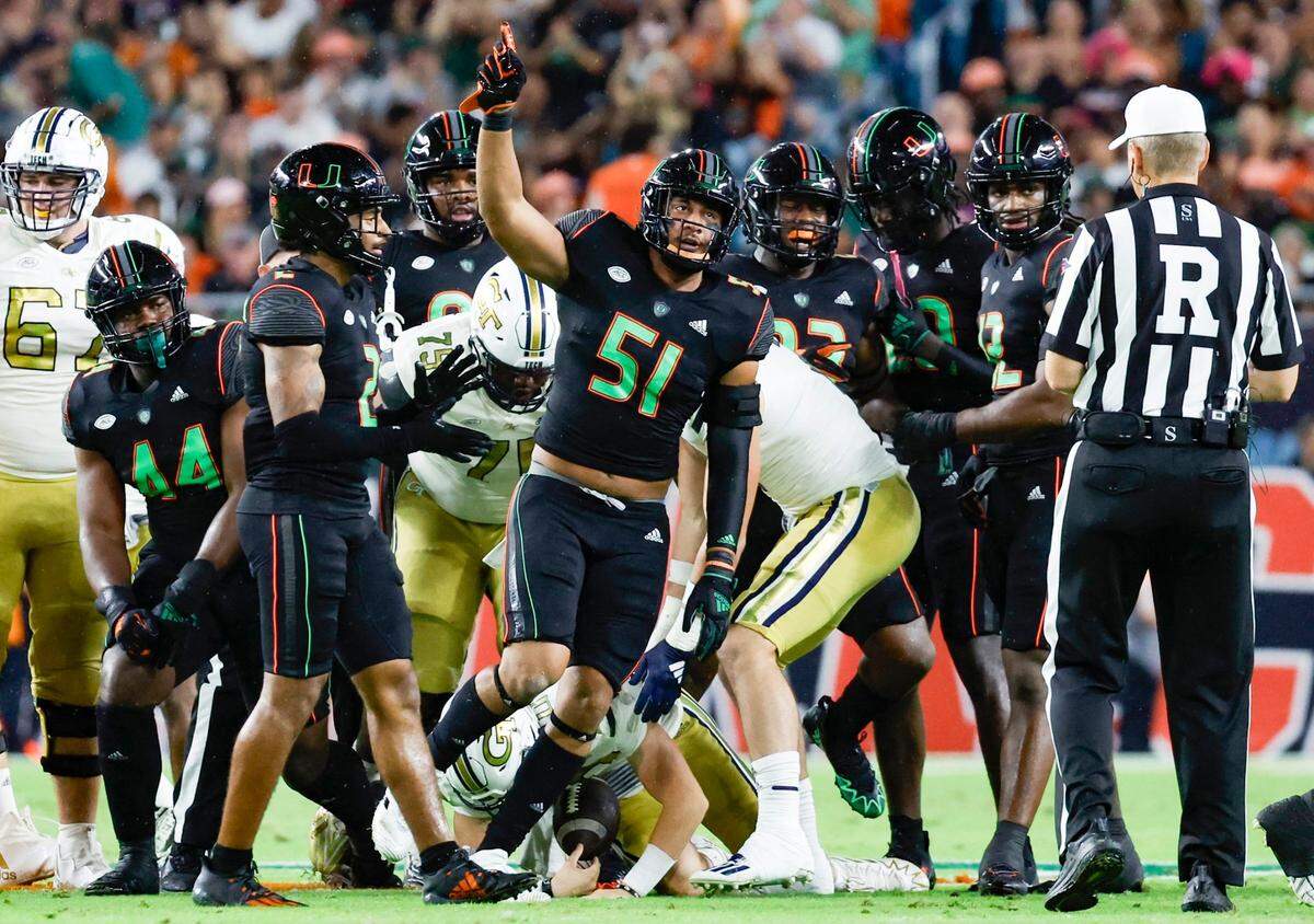 Miami Hurricanes linebacker Francisco Mauigoa (51) reacts after sacking Georgia Tech Yellow Jackets quarterback Haynes King (10) in the first quarter at Hard Rock Stadium in Miami Gardens on Saturday, October 7, 2023.