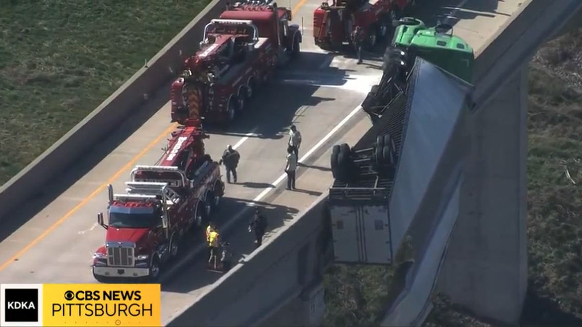 A semi dangled along a Pennsylvania overpass after the driver crashed into a cement barrier