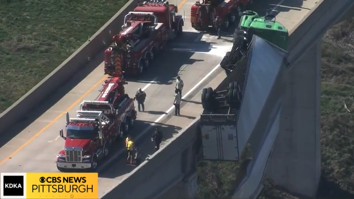 A semi dangled along a Pennsylvania overpass after the driver crashed into a cement barrier