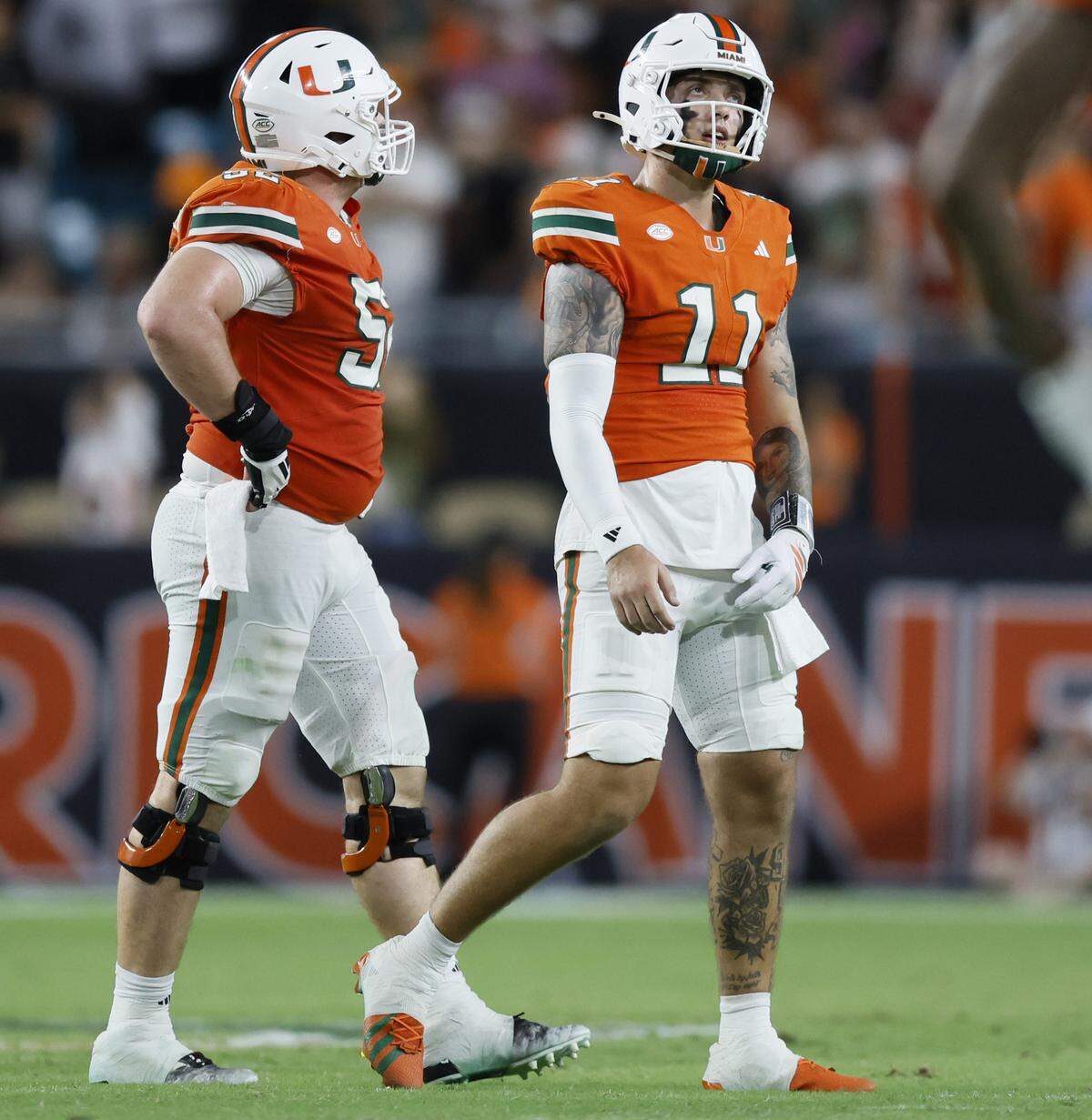 Miami Hurricanes quarterback Carson Beck (11) reacts after an interception by Louisville Cardinals linebacker T.J.Capers (11) on a pass intended for Miami Hurricanes tight end Elija Lofton (9) late in the fourth quarter of their NCAA football game at Hard Rock Stadium in Miami Gardens, Florida, on Friday, October 17, 2025.