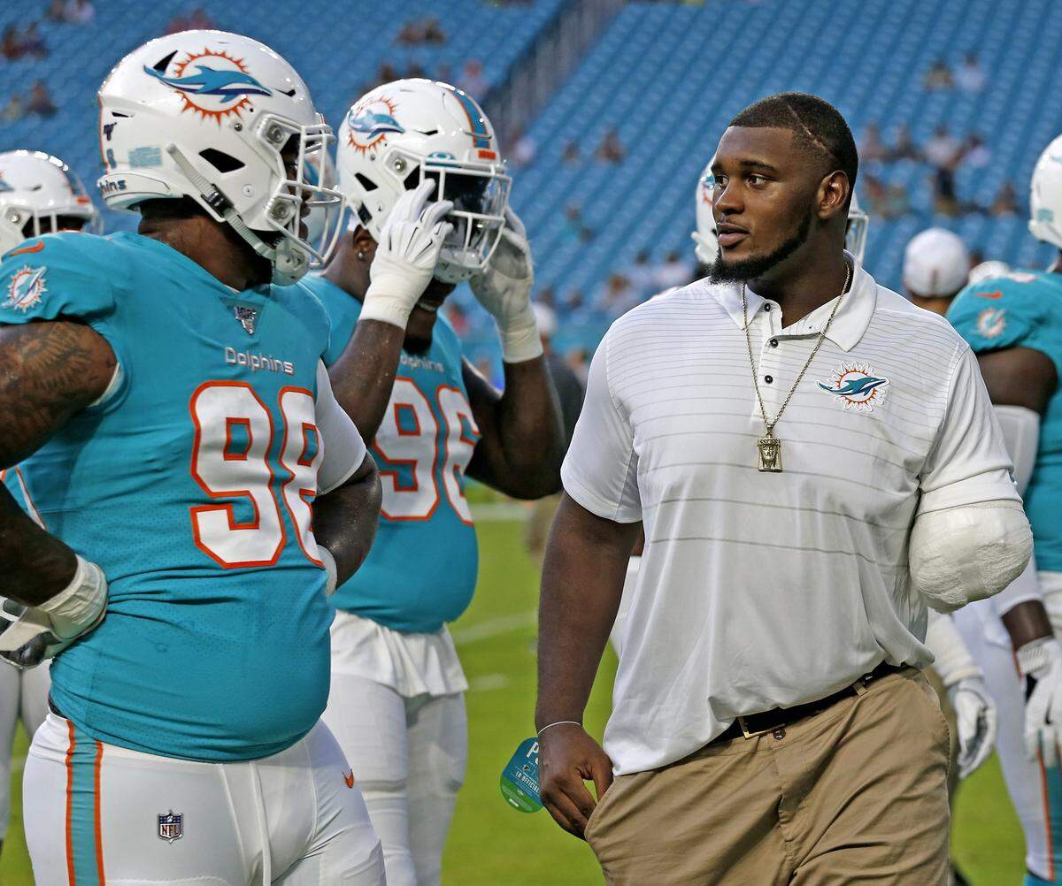 An injured Miami Dolphins defensive tackle, Kendrick Norton, watches the team practice before the Miami Dolphins host the Atlanta Falcons at Hard Rock Stadium in Miami Gardens on Thursday, August 8, 2019.