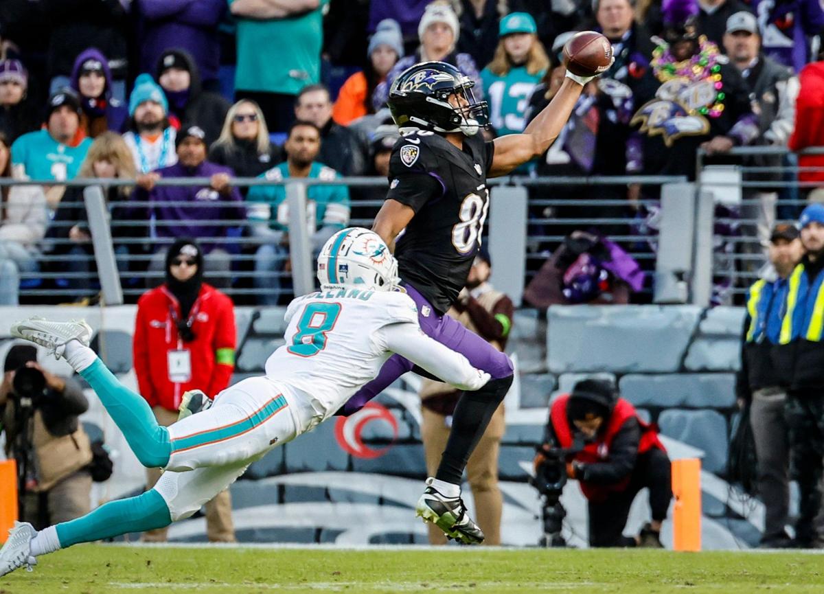 Baltimore Ravens tight end Isaiah Likely (80) on a one-handed pass reception for a touchdown as Miami Dolphins safety Jevon Holland (8) defends in the second quarter at M&T Bank Stadium in Baltimore, Maryland on Sunday, December 31, 2023.