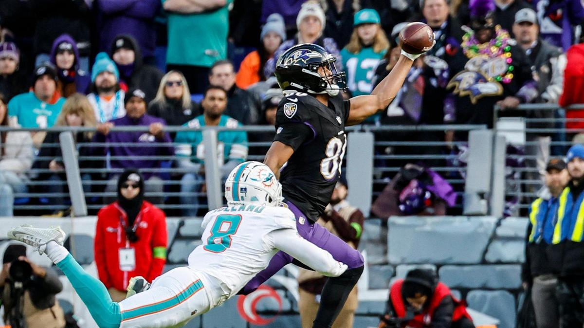 Baltimore Ravens tight end Isaiah Likely (80) on a one-handed pass reception for a touchdown as Miami Dolphins safety Jevon Holland (8) defends in the second quarter at M&T Bank Stadium in Baltimore, Maryland on Sunday, December 31, 2023.