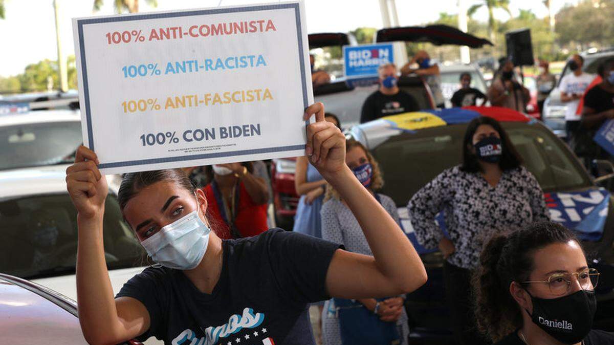 At a South Florida rally in October, Sophia Hildalgo holds a sign that makes clear that she supports Democratic candidate Joe Biden, now the president-elect.