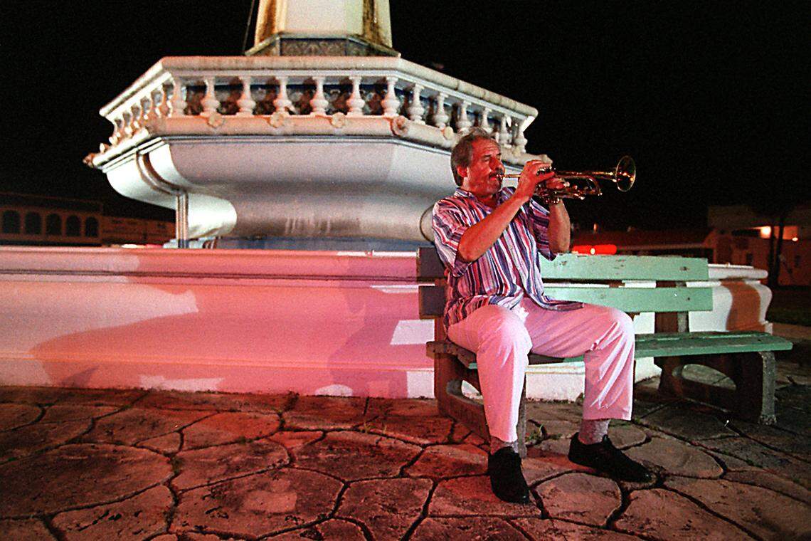 In this file photo from Oct. 6, 1994, Ira Sullivan, originally a Chicago jazz musician who had been playing music since age 3, warms up outdoors before playing at the MoJazz Cafe in Miami Beach.