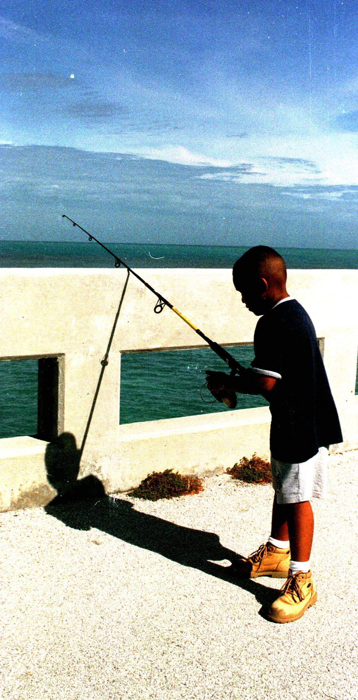 Sabastian Tuff of Fort Lauderdale tests his skill in the waters of the Gulf of Mexico Friday while fishing from the southern end of the old Seven Mile Bridge. He was down with parents and grandparents for a day of angling in the keys.