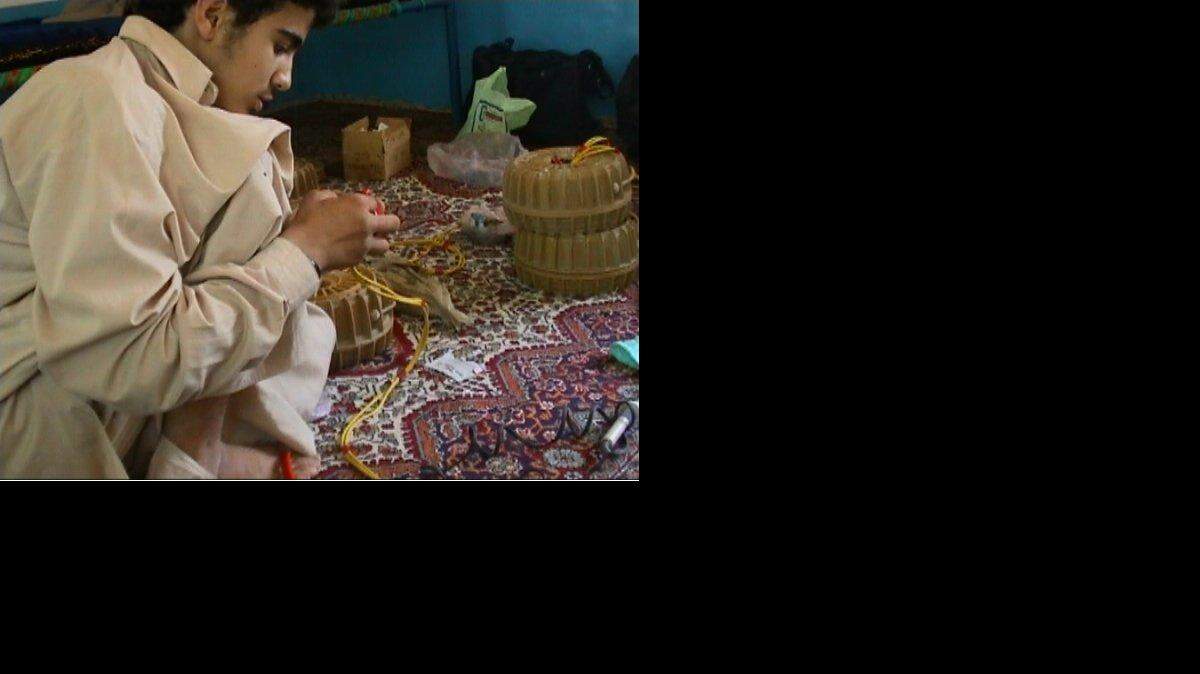 Omar Khadr, at age 15, in the summer of 2002, learning to build land mines in Afghanistan, in a photo used as an exhibit by a war court prosecutor at the U.S. Navy base at Guantanamo Bay, Cuba. The prosecution asked a jury to sentence Khadr, now 24, to 25 years. The jury instead gave him 40.