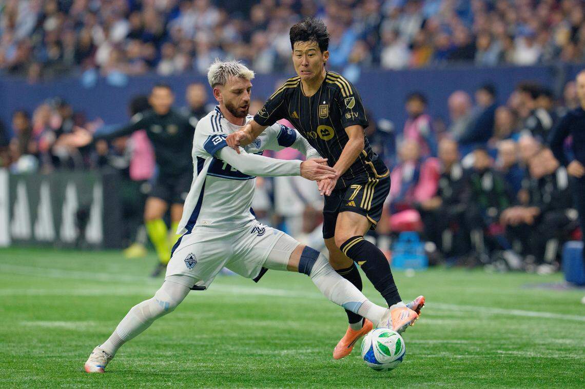 VANCOUVER, BRITISH COLUMBIA - NOVEMBER 22: Son Heung-Min #7 of Los Angeles FC is challenged by Tristan Blackmon #33 of Vancouver Whitecaps FC during the conference semifinal between Vancouver Whitecaps FC and Los Angeles Football Club at BC Place as part of the 2025 MLS Cup Playoffs on November 22, 2025 in Vancouver, British Columbia. (Photo by Jeff Vinnick/Getty Images)