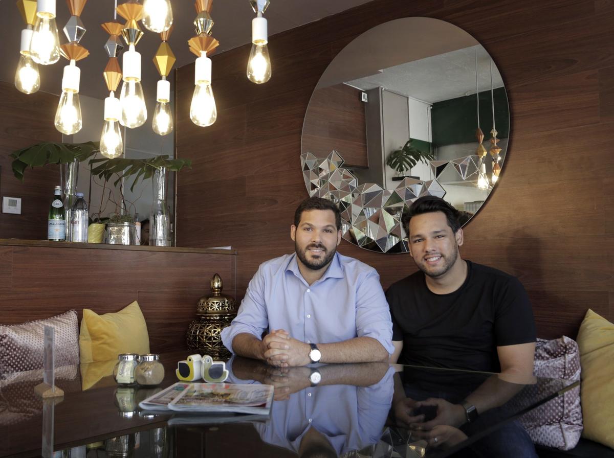 Ivan Nieves, left, and his husband, David Flores, moved to Miami from Puerto Rico after Hurricane Maria destroyed their home in the Condado suburb of San Juan.  They opened a second version of their restaurant, La Social, in Miami, at 7601 Biscayne Blvd., while popular demand helped them reopen their original restaurant on the island.