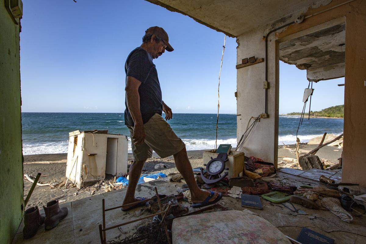 The Atlantic Ocean swept away the home of Rafael Rosario Quintero, 70, who lives on the coast of La Boca in Barceloneta, Puerto Rico. Here, Quintero looks at the debris still sitting in what is left of his bedroom.
