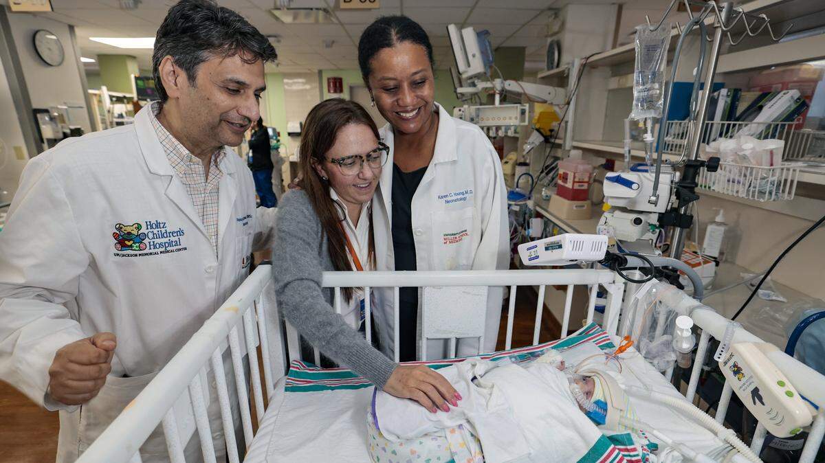 Dr. Pankaj Agrawal, Marcella McCarthy, and Dr. Karen Young at the bedside of McCarthy's premature born baby at Neo-Natal Intensive Care Unit at Holtz Children's Hospital in Miami, Florida, on Friday, September 5, 2025.