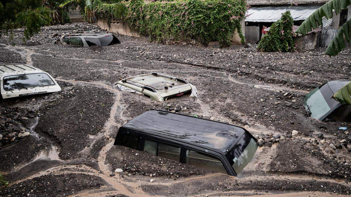 Cars are submerged in mudin Petit-Goave, Haiti.f ollowing Hurricane Melissa’s torrential rains.