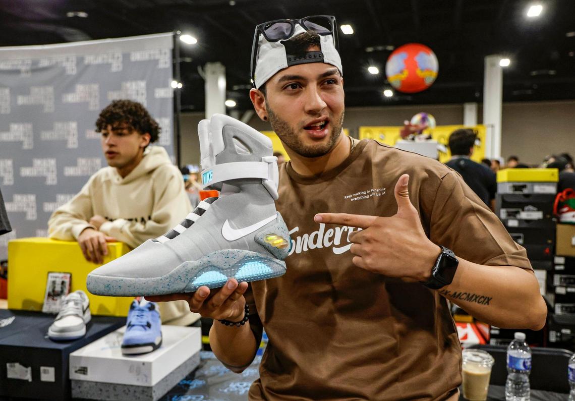 Richard Escobar, 25, reacts as he picks up a pair of 2011 Nike Air Mag sneakers that were seen in the movie “Back to the Future Part II” during Sneaker Con at the Broward County Convention Center in Fort Lauderdale, Florida, on Saturday, Jan. 11, 2025.