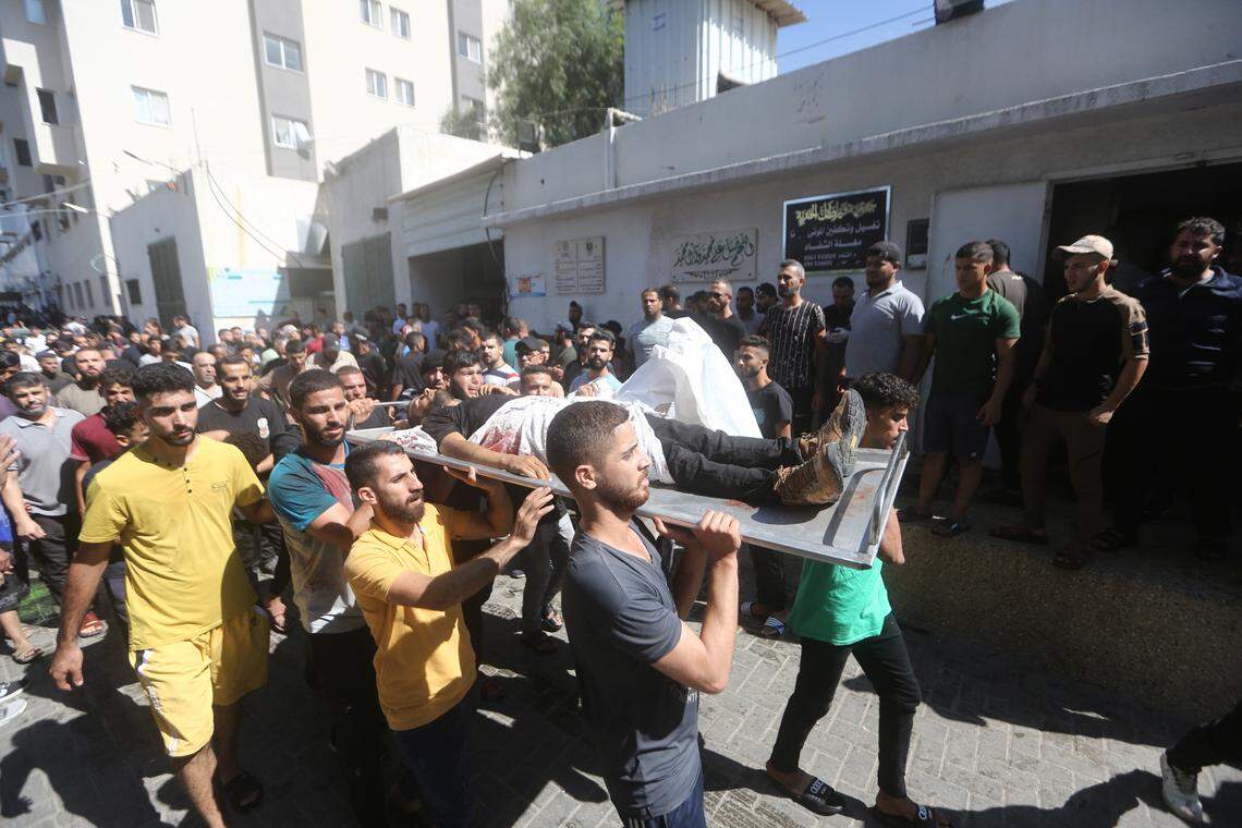 Mourners carry the bodies of Palestinians killed in the latest infiltration into Israel, outside Shifa Hospital in Gaza City. Several armed Palestinians have entered Israeli territory during the barrage of rocket attacks from the Gaza Strip, according to army sources.