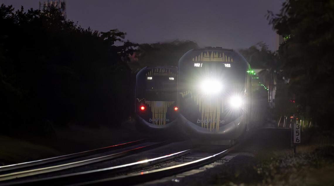 A southbound Brightline train passes a northbound Brightline train stopped on the tracks after it collided with a vehicle near Biscayne Boulevard in Miami on Nov. 19, 2025.