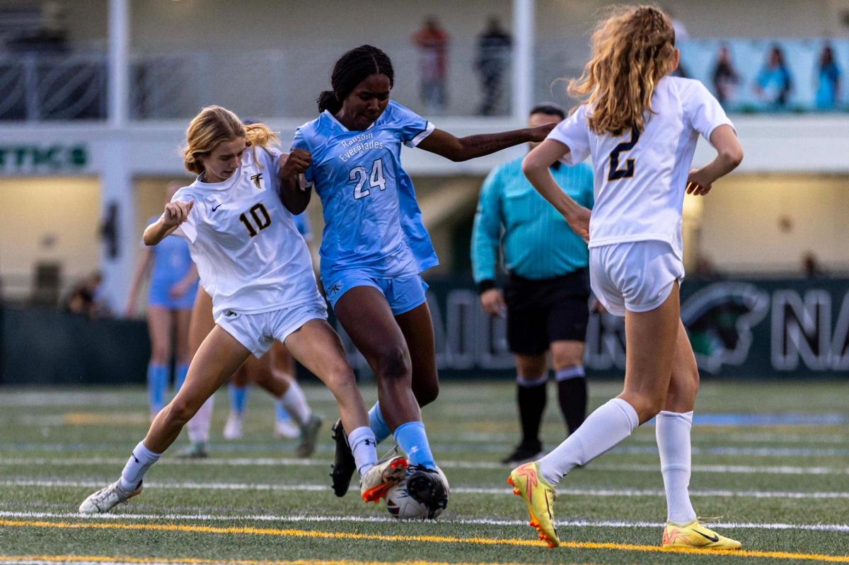 Ransom Everglades attacker Johanna James (24) fights for possession of the ball with Palmer Trinity defender Arianna Adessi (10) during the girls soccer 4-2A Regional Final on Wednesday, February 19, 2025, in Coconut Grove, Florida.