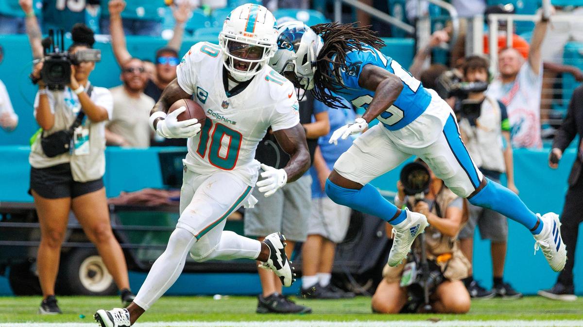 Miami Dolphins wide receiver Tyreek Hill (10) scores a touchdown as Carolina Panthers cornerback Donte Jackson (26) defends during second quarter of an NFL football game at Hard Rock Stadium on Sunday, Oct. 15, 2023 in Miami Gardens, Fl.