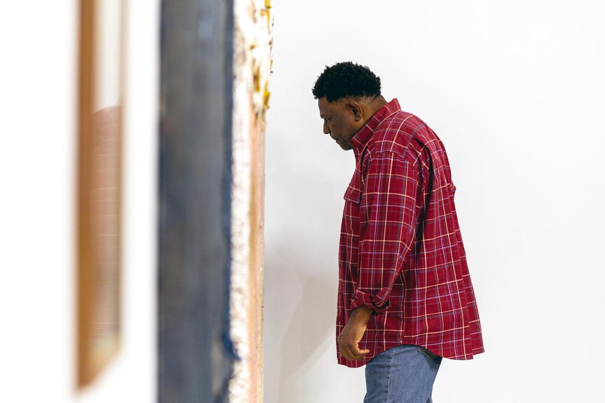 A man views artwork during the Preview for The Art of Transformation event at The ARC and Logan Building in Opa-locka, Florida, on Wednesday, November 30, 2022. The event is a five-day, three-block Mecca of African and Haitian art fair coinciding with Art Basel Miami Beach 2022 and just one of over 40 ‘exhibits’ part of 2022 Art of Black Miami.